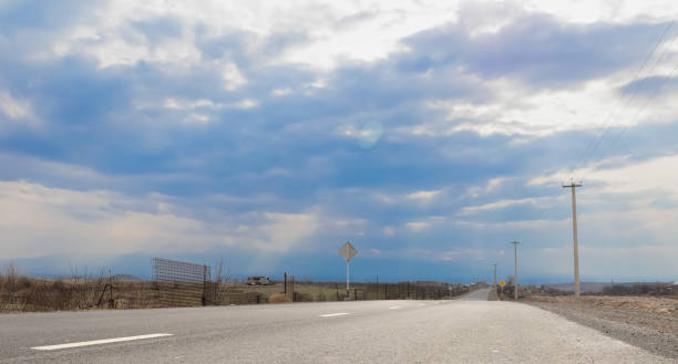 istock Asphalt road passing through the countryside 1476265432