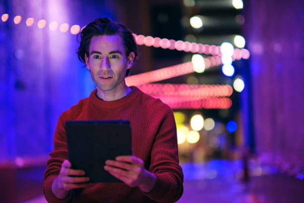 istock Young Man Using a Digital Tablet in a City at Night 1476266838