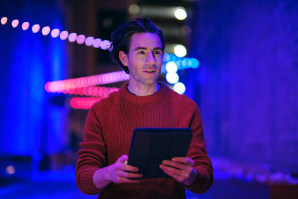 istock Young Man Using a Digital Tablet in a City at Night 1476266879