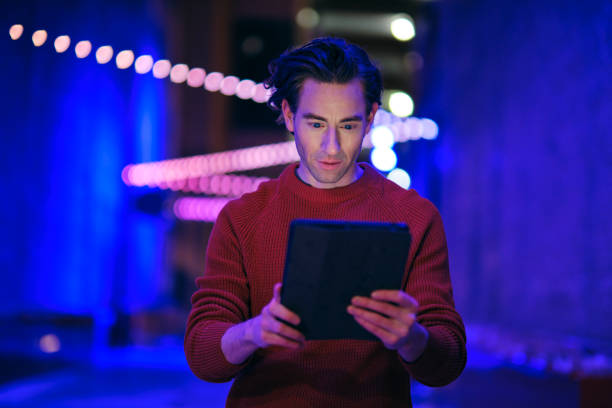 istock Young Man Using a Digital Tablet in a City at Night 1476266912
