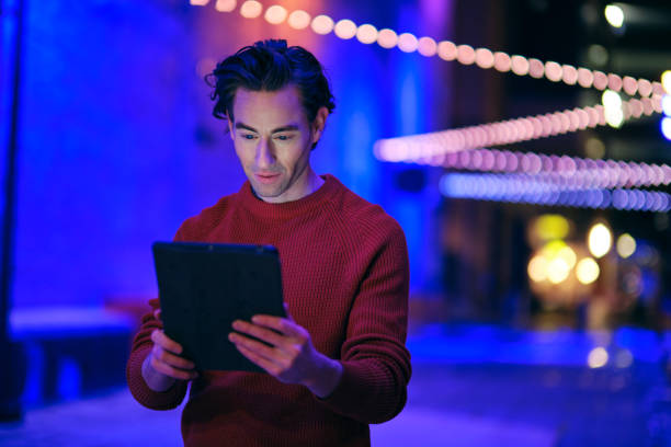 istock Young Man Using a Digital Tablet in a City at Night 1476266930