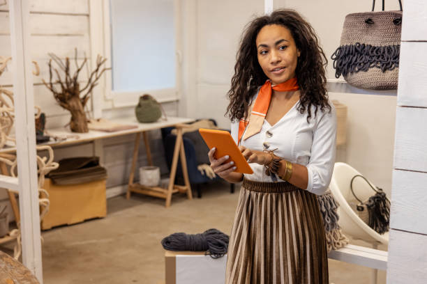 istock Young woman with a tablet in hands looking busy and thoughtful 1476267498