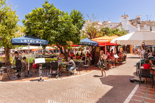Marbella, Spain, June 11, 2022; Cozy little square with restaurants on the Plaza de los Naranjos square in the old center of Marbella.