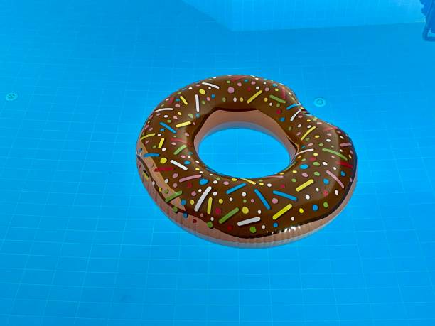 istock Donut-shaped life ring floating in the pool 1476268984