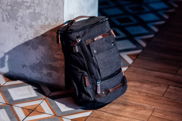 istock Canvas backpack for travelers. Canvas Backpack accessories in interior background. 1476270204