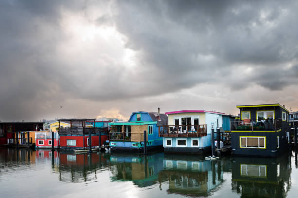 Colorful, painted and restored houseboats are reflected in the still water of Richardson Bay in Sausalito, California.
