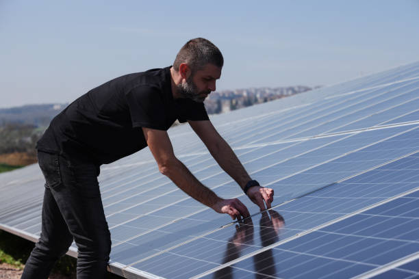 istock Bearded man checking solar panels on his farm 1476272658