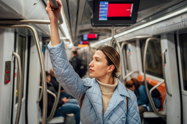 istock Woman standing and holding a handrail in the subway train 1476272685