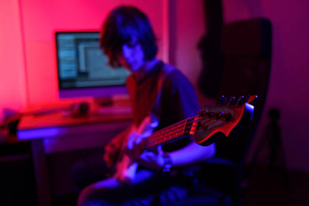 istock Bassist playing in his studio -special lighting effects 1476272796