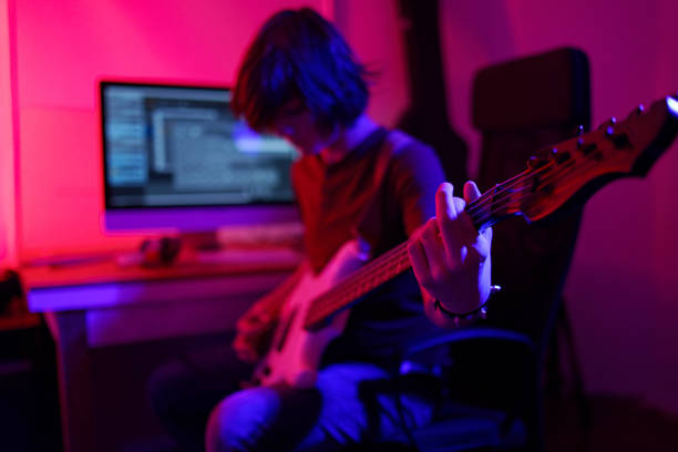 istock Bassist playing in his studio -special lighting effects 1476272881