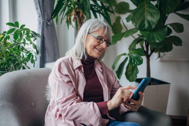 istock Modern senior woman using phone 1476273001