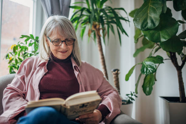 istock Senior woman reading a book 1476273280