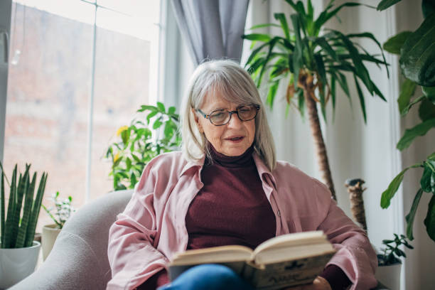 istock Senior woman reading a book 1476273853