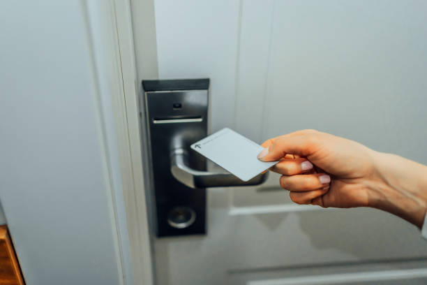 istock Woman's hand inserting key card in an electronic lock 1476273861