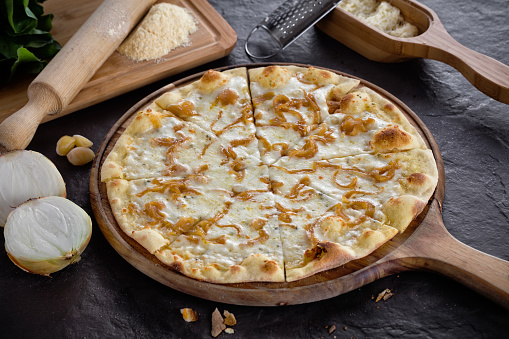 Delicious mixed pizza with mozzarella, onion and garlic. Italian food image.