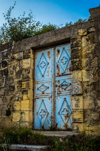 istock Blue door and an old stone wall 1476277523