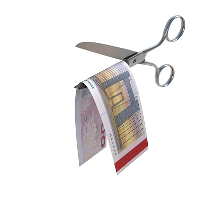 Danish Krone bill being cut in half with scissors