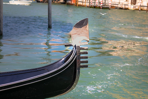 Gondola's bows moored in the Grand Canal at Venice, Italy