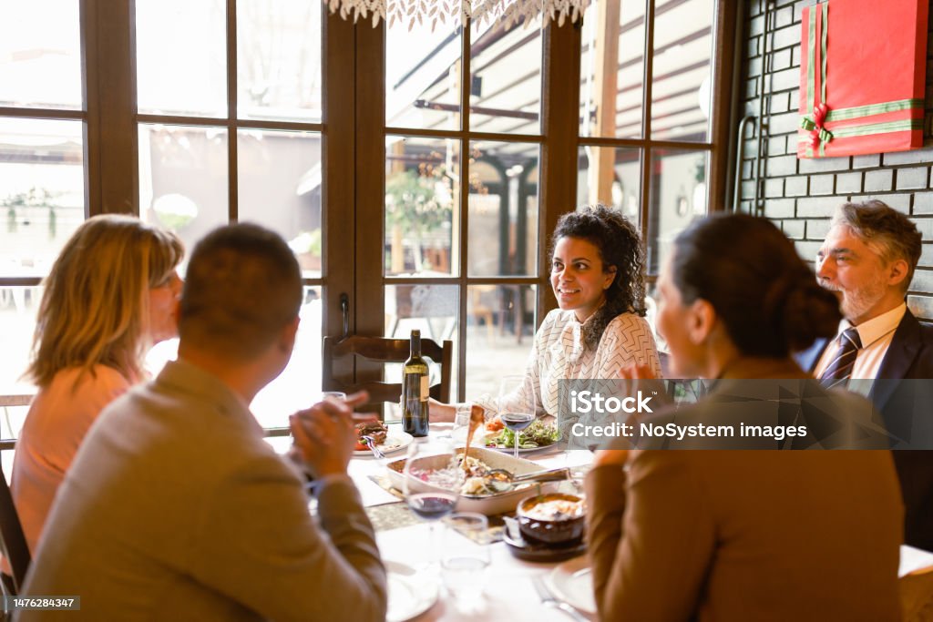 Colleagues Enjoying a Business Lunch A group of coworkers gather for a sophisticated business lunch at an upscale restaurant, enjoying both the exquisite cuisine and each other's company Lunch Stock Photo