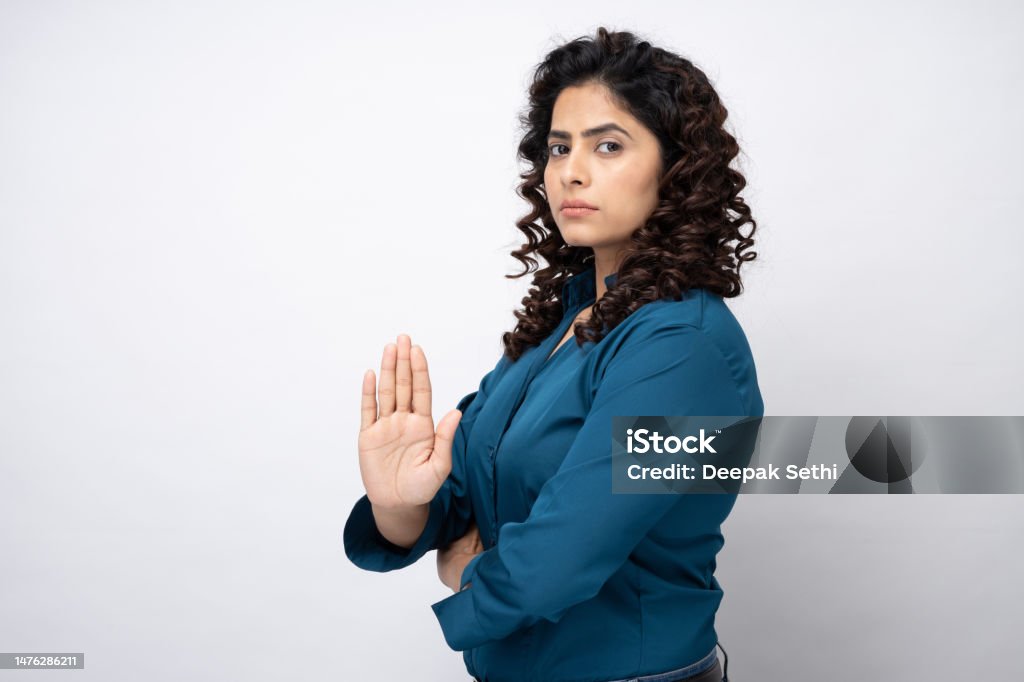 Prohibition sign, portrait of young businesswoman serious making stop sign with her hand on white background stock photo Prohibition sign, portrait of young businesswoman serious making stop sign with her hand on white background Businesswoman Stock Photo