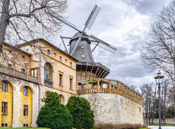 Potsdam, Germany - January 02, 2023: Ancient traditional wooden wind mill near the Sanssouci Royal Palace and Park in Potsdam. Famous landmark in Germany