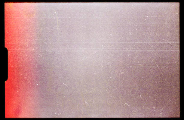 istock empty or blank super 8mm film frame with black border and dust. film texture. 1476297521