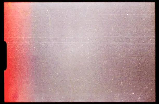 Photo of empty or blank super 8mm film frame with black border and dust. film texture.