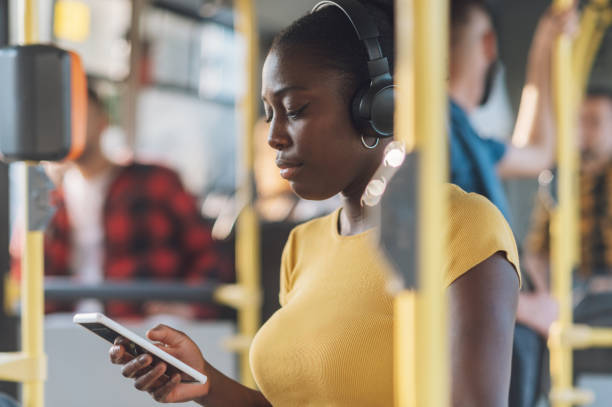 istock African american woman riding in a bus and using a smartphone 1476298210
