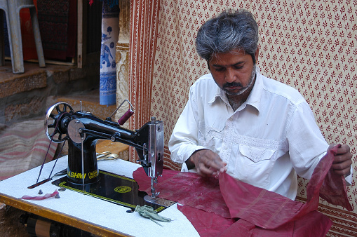Jaisalmer, Rajasthan, India - March 12, 2006: Street tailor working on a street in the historic center of the city