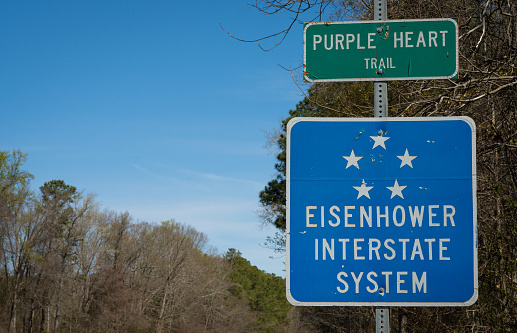 A sign denotes a US highway as part of the Eisenhower Interstate System.