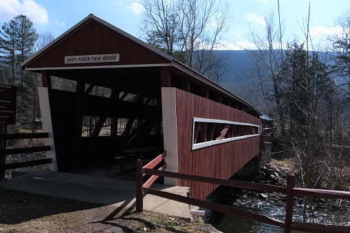 Historic red Twin covered bridges located in Columbia County Pennsylvania.  Built in 1884 of the Queen Truss Burr Arch construction over Huntington Creek over 112 feet long.  Listed on the National Register of historic places.