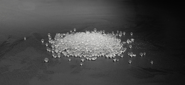 Desiccant Silica Gel Adsorbent Crystals on Black Background Top View, Desiccant Polymer Balls, Silicagel Closeup