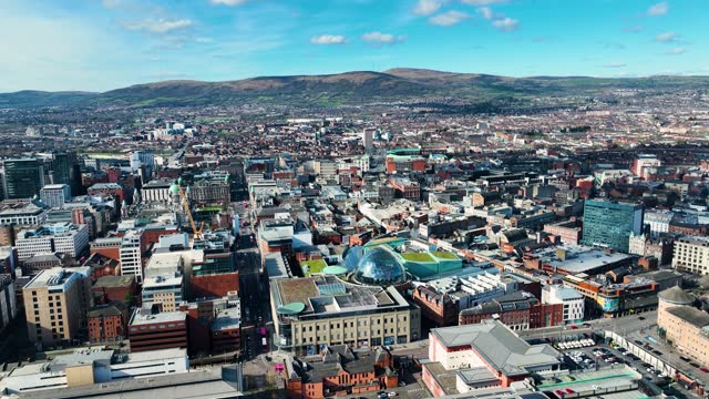 Aerial video of Belfast City Hall Cityscape Skyline on a sunny day in Northern Ireland