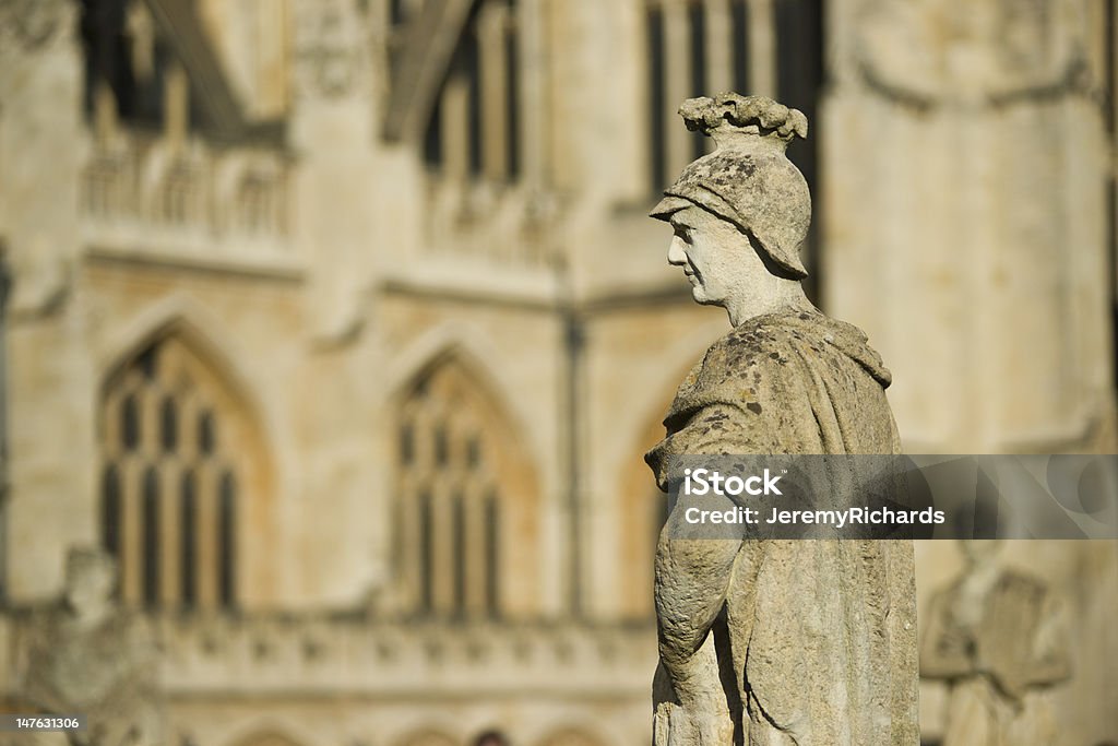 Relic of the past Old weathered stone statue above the ancient Roman Baths in Bath, Somerset, England. Bath Abbey in the background. Architecture Stock Photo