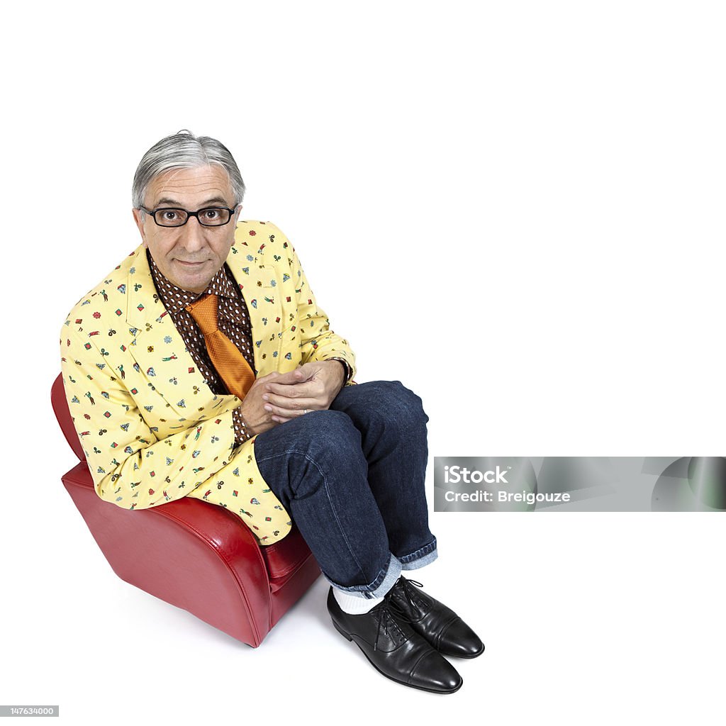 Nerd.Bis. Colorful nerd senior sitting on a small red armchair. Humor Stock Photo