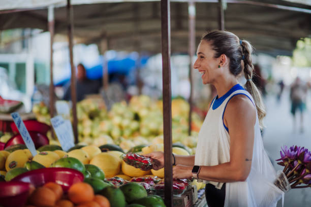 istock woman visiting the fruit fair in the morning 1476340548