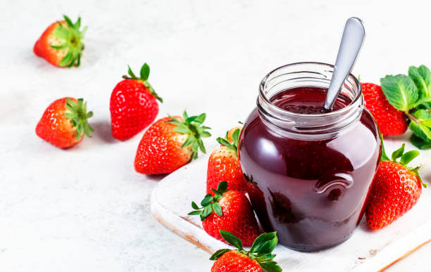istock Strawberry jam in glass jar and fresh berries, white table background, copy space 1476341500