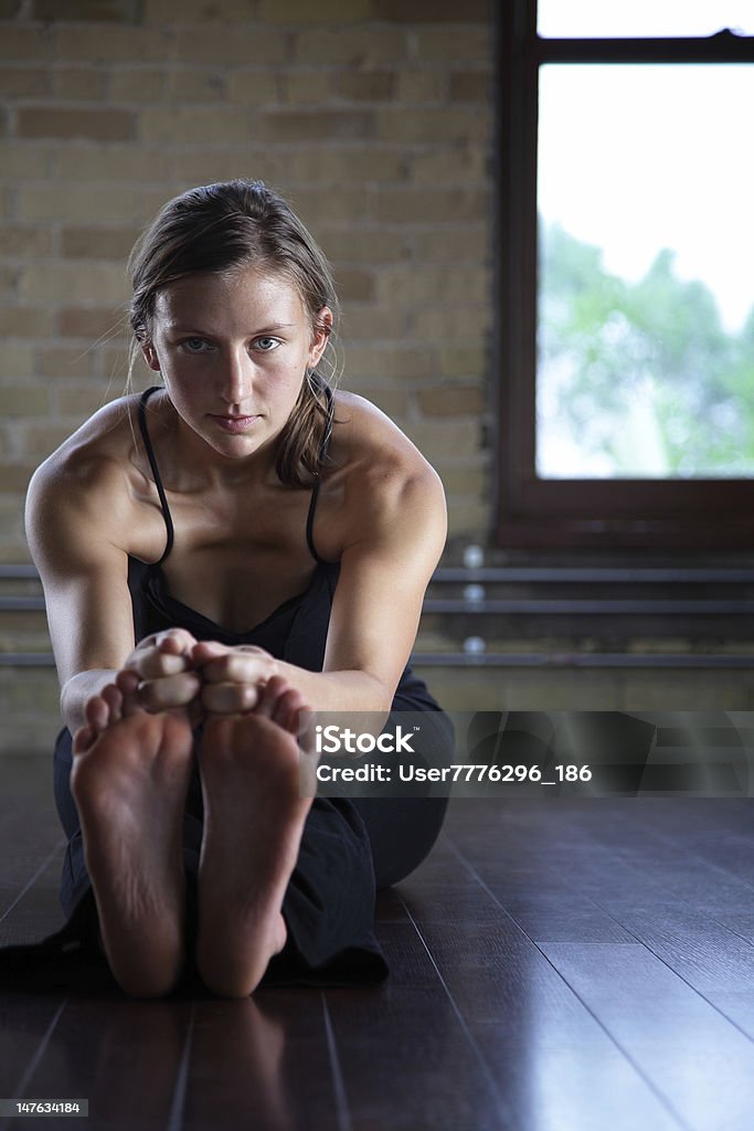 Hot Yoga Woman in hot yoga forward fold pose Adult Stock Photo