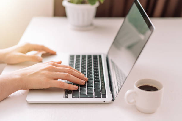 istock Lady typing on a laptop at the table 1476342123