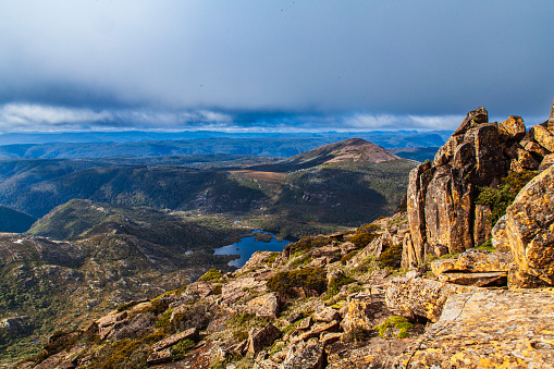 View of vast rugged mountain and valley terrain in cradle mountain national park on a sunny day. Tasmania, Australia.