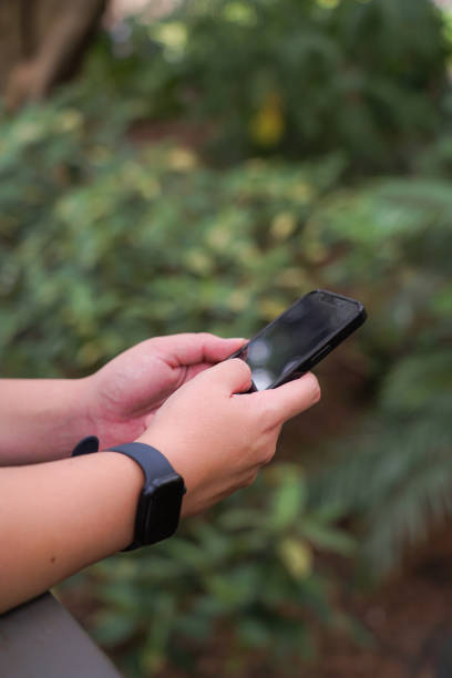 istock A person in nature using a smart phone and wearing a smart watch 1476353359