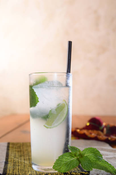 istock Refreshing summer mojito cocktail with ice and mint Tropical lemonade, grapefruit, pear and berries. 1476356484