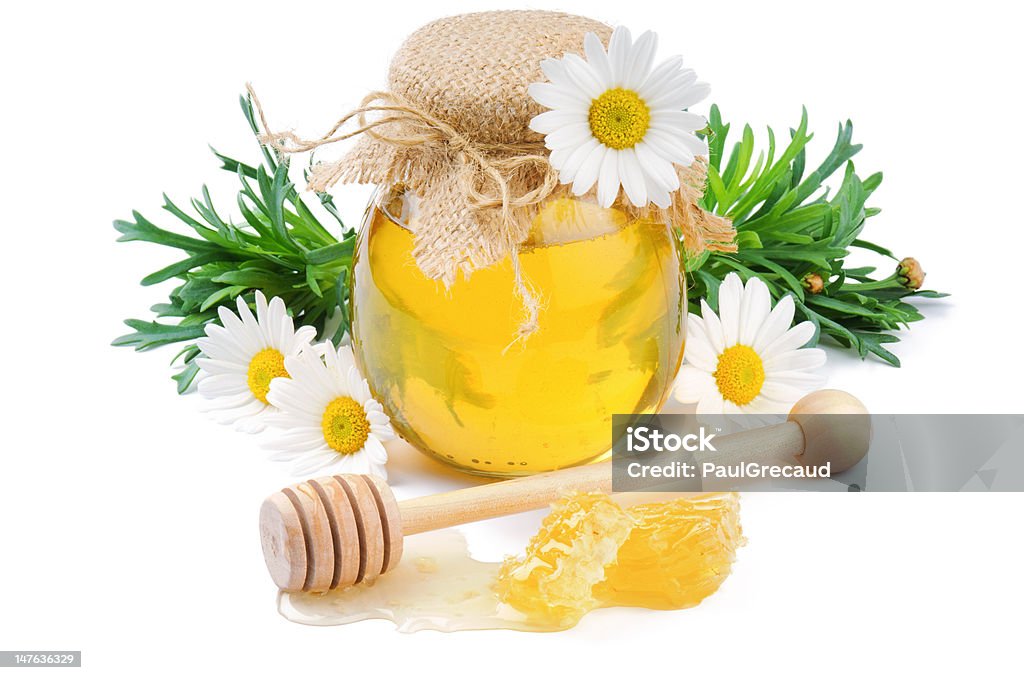 Vintage honey pot with daisies Vintage honey pot with daisies, comb and drizzler Acacia Tree Stock Photo