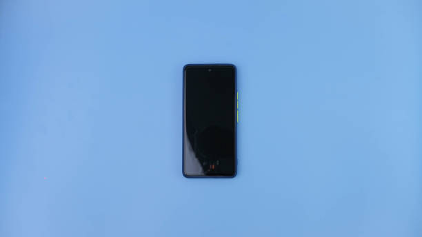 istock Mobile phone isolated on blue background. 1476365505
