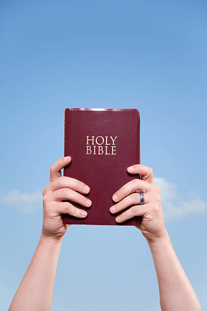 Married Man Holding Bible to Sky stock photo