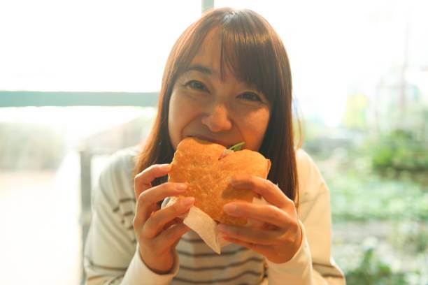 Sandwich in woman hand in sunlight.