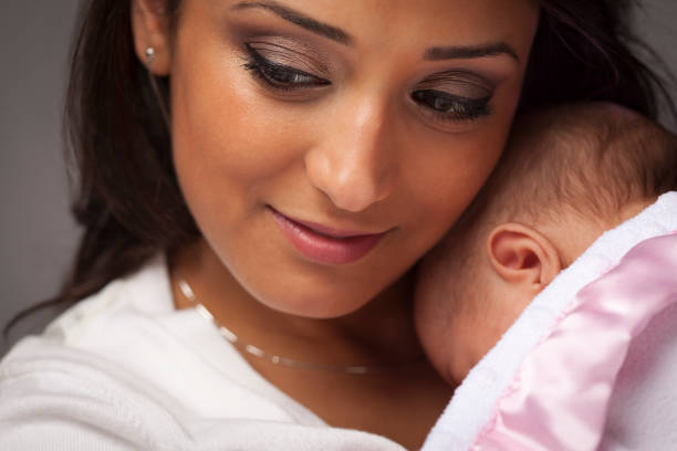 istock Attractive ethnic woman holding her baby 147641109