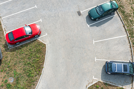 parking lot with parked cars. aerial closeup drone view from above.