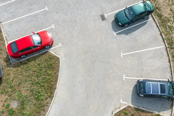Photo of parking lot with parked cars. aerial closeup drone view from above.