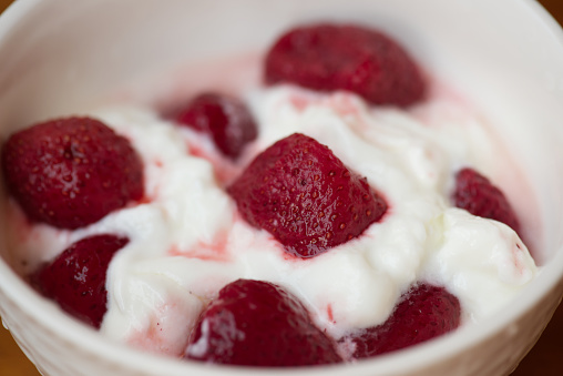 Yogurt topped with strawberries.